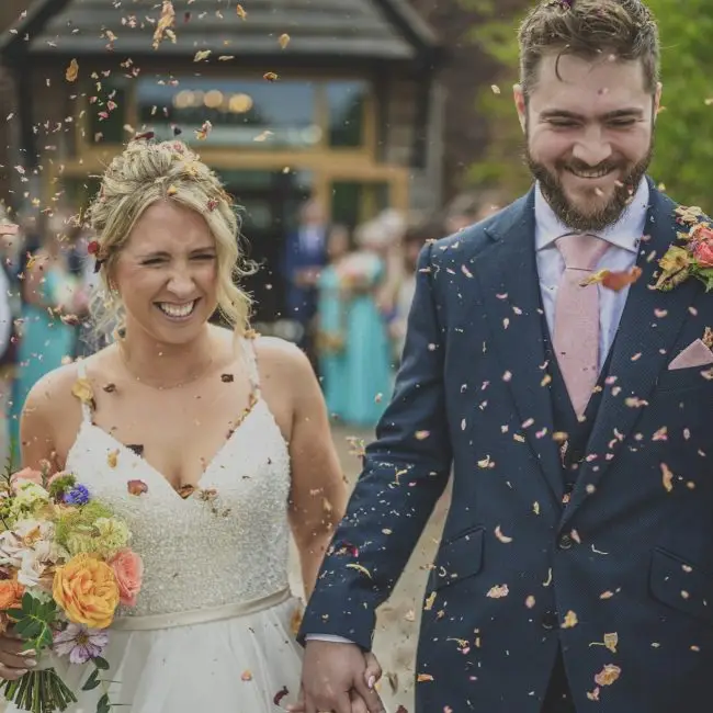 An awesome documentary style wedding photo of a couple surrounded by confetti!